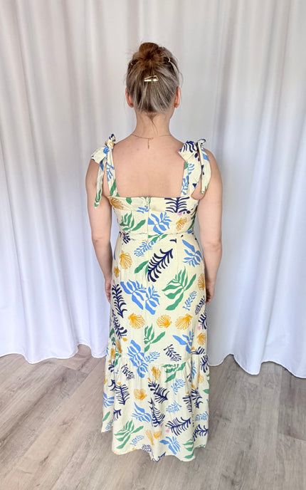 Full-length back view of the Marina Maxi Dress, highlighting the hidden back zipper closure, the elegant tie finishes of the wide shoulder straps, and the smooth, fully lined drape of the dress.