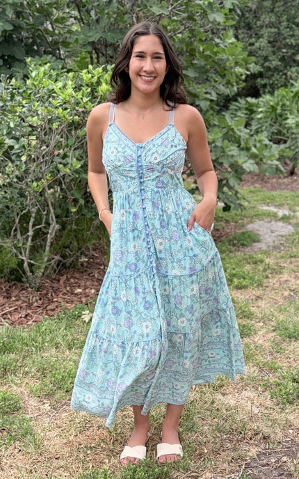 A natural, relaxed shot of the model placing her hand inside the functional side pocket of the flowy skirt.