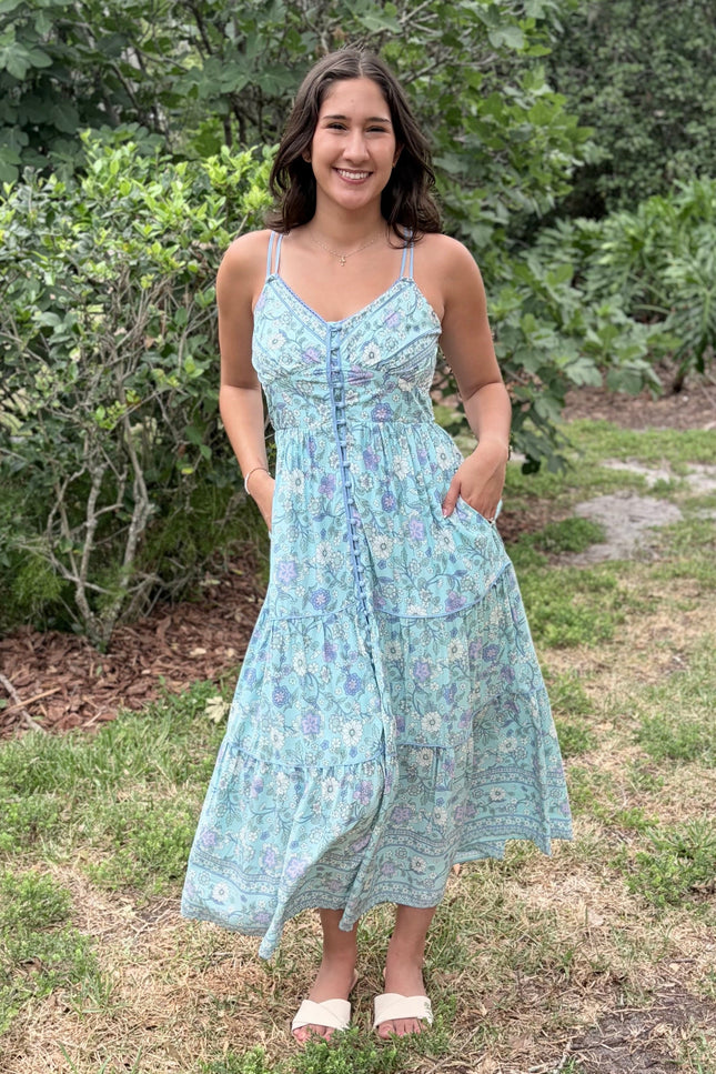 A natural, relaxed shot of the model placing her hand inside the functional side pocket of the flowy skirt.