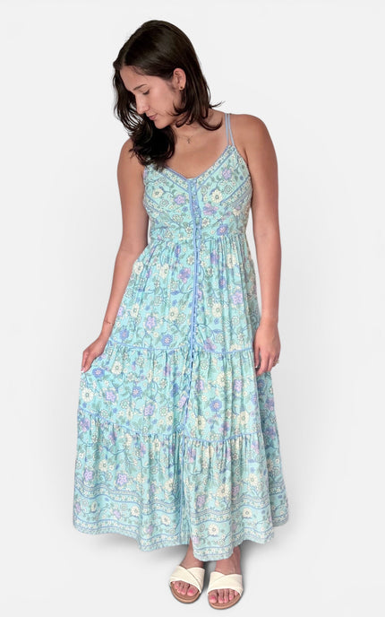 A natural, relaxed shot of the model placing her hand inside the functional side pocket of the flowy skirt.