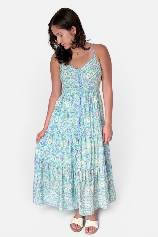 A natural, relaxed shot of the model placing her hand inside the functional side pocket of the flowy skirt.