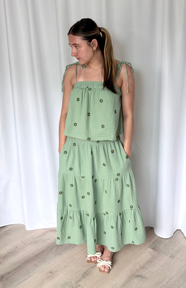 Detail shot of smocked elastic waistband and side pocket on tiered double gauze midi skirt