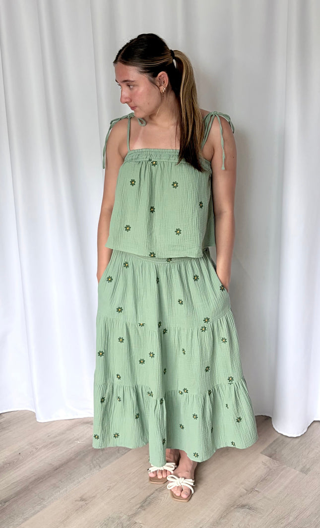 Detail shot of smocked elastic waistband and side pocket on tiered double gauze midi skirt