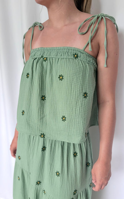 Close-up of handcrafted floral embroidery on double gauze cotton with natural texture detail