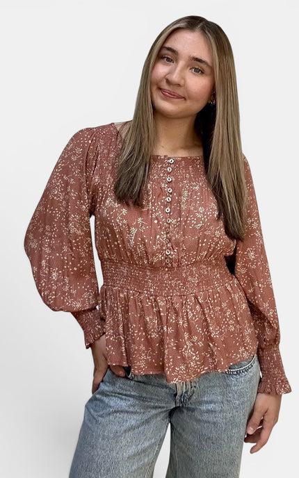 Front view of women's ditsy floral peasant top with smocked waist.