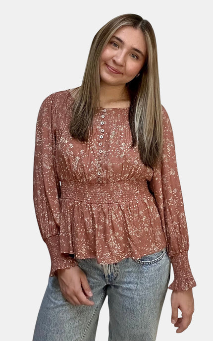 Front view of rayon floral top with smocked waist.