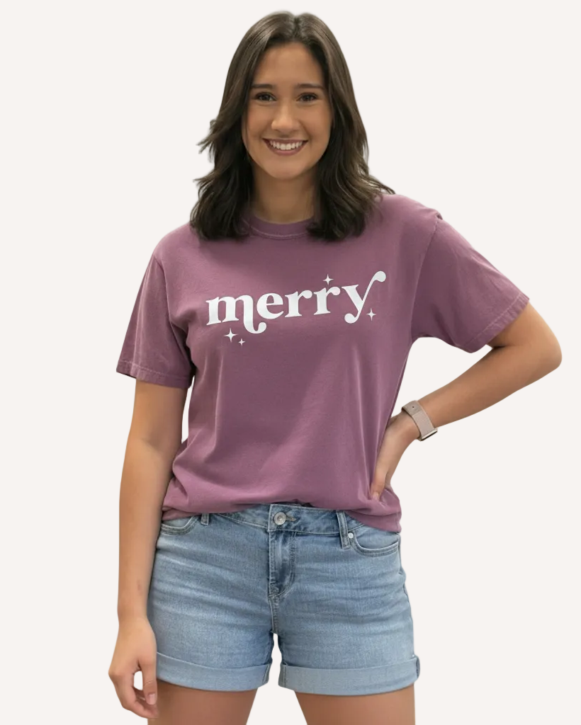 Person wearing a purple t-shirt with 'merry' text on a plain background