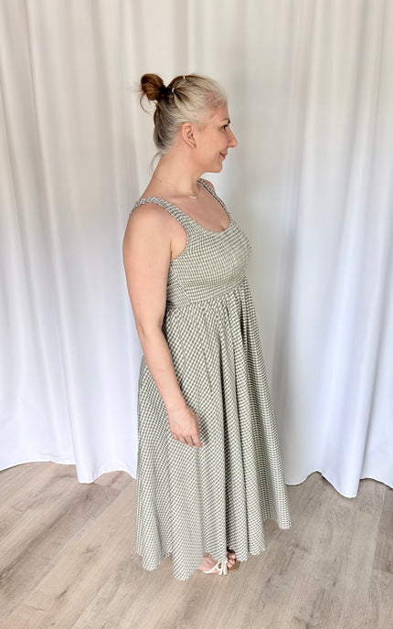 Side profile of the Nora Maxi Dress, emphasizing the flattering, waist-defining fit of the bodice and the effortless, graceful drape of the 100% cotton maxi skirt.