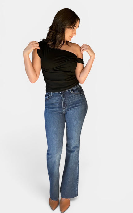 Black one shoulder fitted top featuring a twisted neckline and soft stretch fabric on a brunette model.