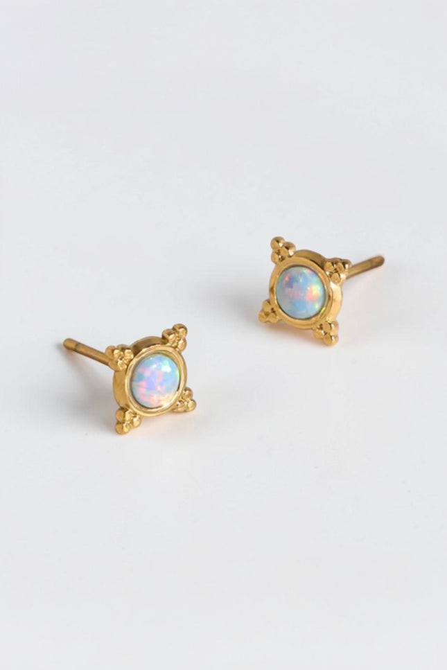A clear, focused close-up of the pair of gold PVD plated stainless steel studs, showcasing the 3.9mm round synthetic opal stone and the delicate beaded frame.