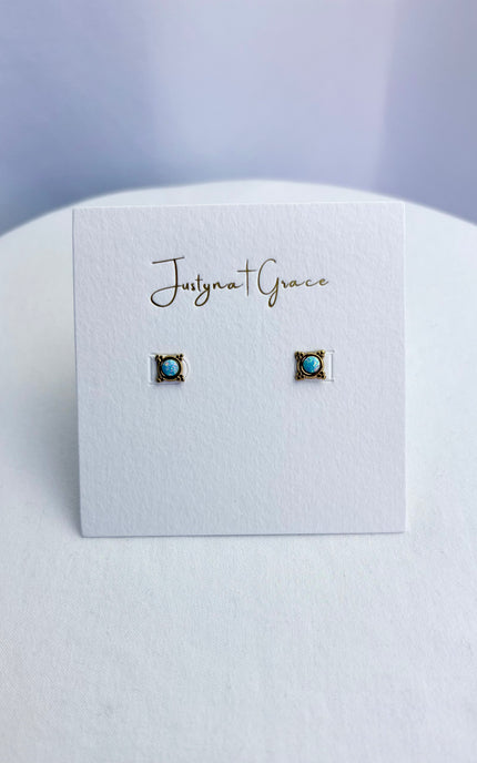 Pair of earrings on a 'Justyna Grace' branded card against a light gray background