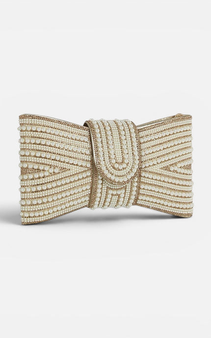 Close‑up of the pearl‑embellished bow showcasing its glossy finish and delicate gold setting.