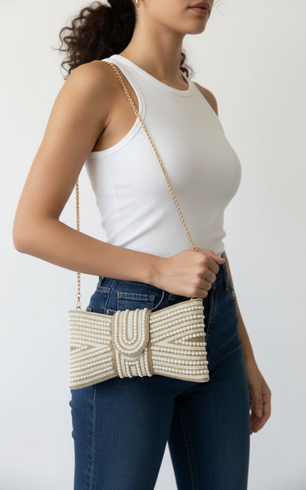 Clutch worn with the detachable shoulder strap for hands‑free styling.