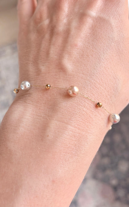 Minimalist pearl bracelet styled alone for an elegant everyday look.