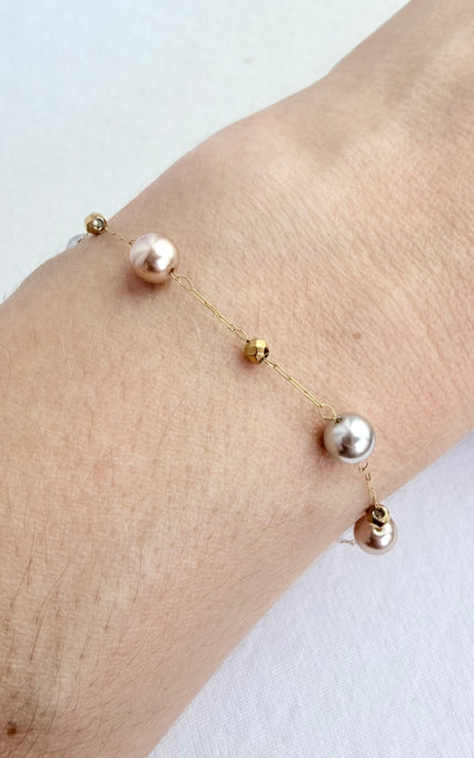 Hypoallergenic gold bracelet featuring imitation pearl accents and a secure clasp.