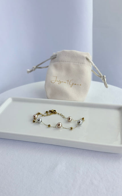 Women's pearl station bracelet crafted with imitation pearls and gold PVD stainless steel.