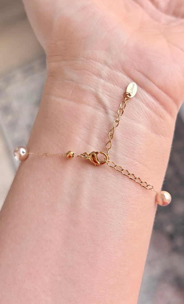 Hypoallergenic gold bracelet featuring imitation pearl accents and a secure clasp.