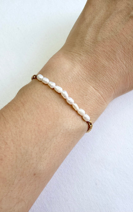 Elegant freshwater pearl bracelet with classic gold toggle clasp, lightweight and waterproof.