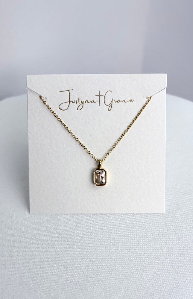 Rectangular zircon pendant necklace displayed on a jewelry card, showing the pendant centered against a clean background.