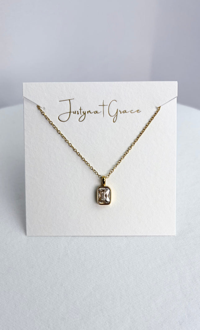 Rectangular zircon pendant necklace displayed on a jewelry card, showing the pendant centered against a clean background.