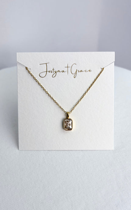 Rectangular zircon pendant necklace displayed on a jewelry card, showing the pendant centered against a clean background.