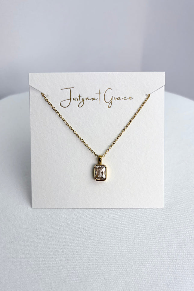 Rectangular zircon pendant necklace displayed on a jewelry card, showing the pendant centered against a clean background.
