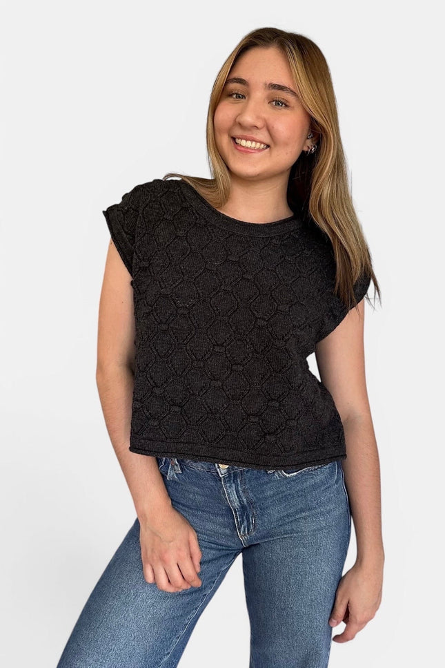 Front view of women’s rolled hem sweater top with popcorn knit texture.