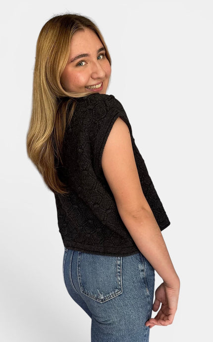 Side view of women’s relaxed fit rolled hem sweater top.