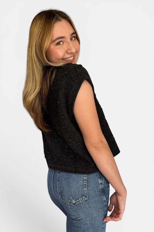 Side view of women’s relaxed fit rolled hem sweater top.