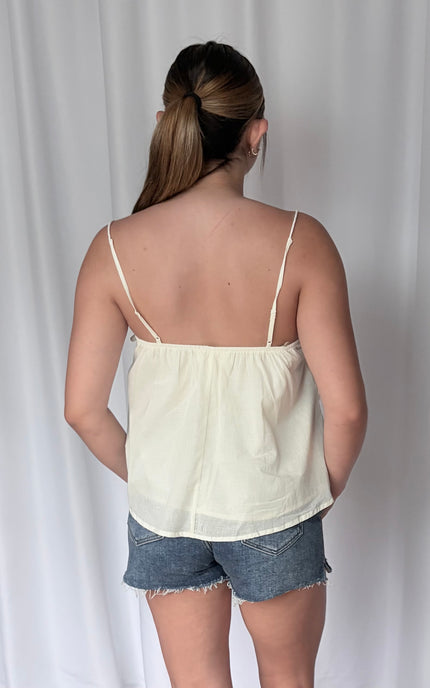 Full back view of the 100% cotton cami, showcasing the airy, lightweight fabric and the hemline that sits at the hip.