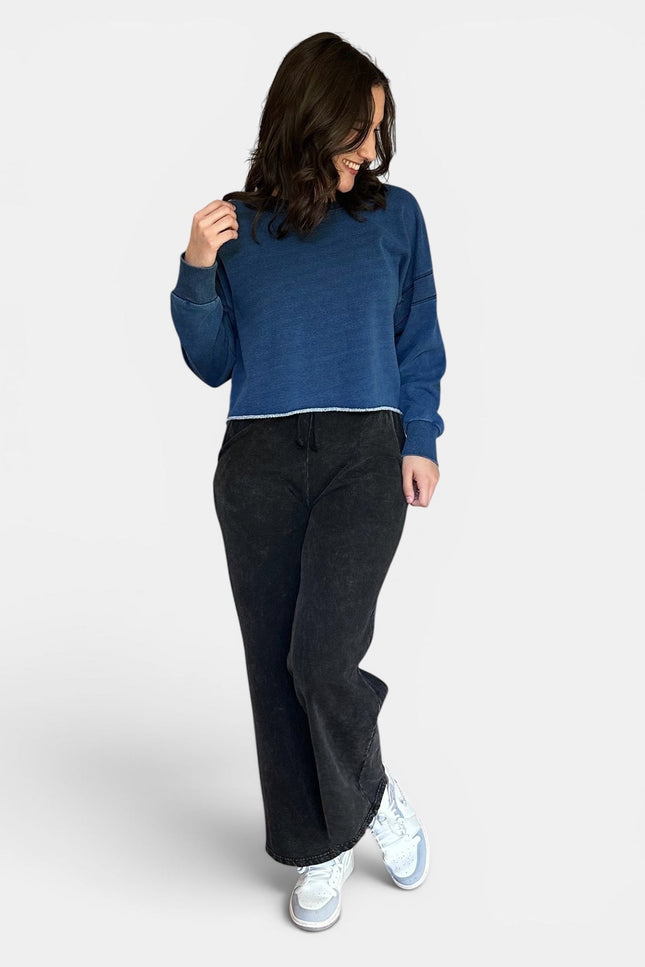 Women's oversized fleece lined denim wash sweatshirt front view.