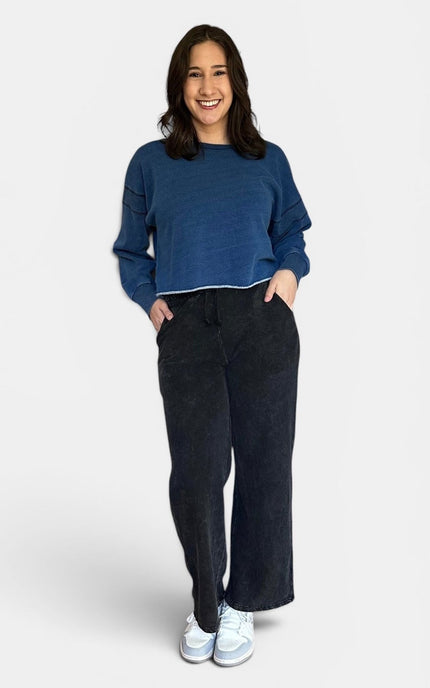 Relaxed fit denim wash sweatshirt with wide neckline and soft fleece interior.