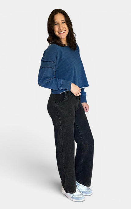 Close-up front of oversized blue denim wash pullover sweatshirt.