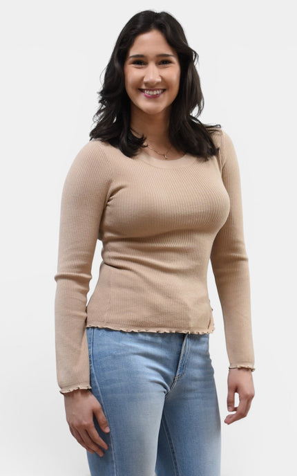 Front angled view of women's ruffle neckline sweater with front slit detail.