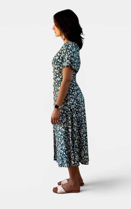 Side view of a lightweight teal floral midi dress with a princess neckline and relaxed fit.