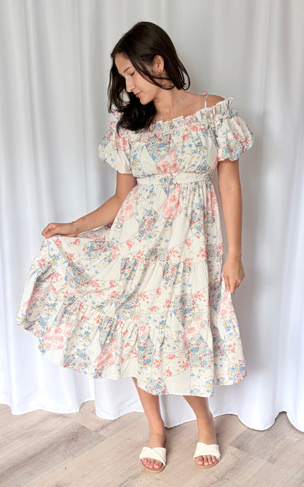 Skirt tier detail on romantic floral midi dress showing mixed print and breezy movement