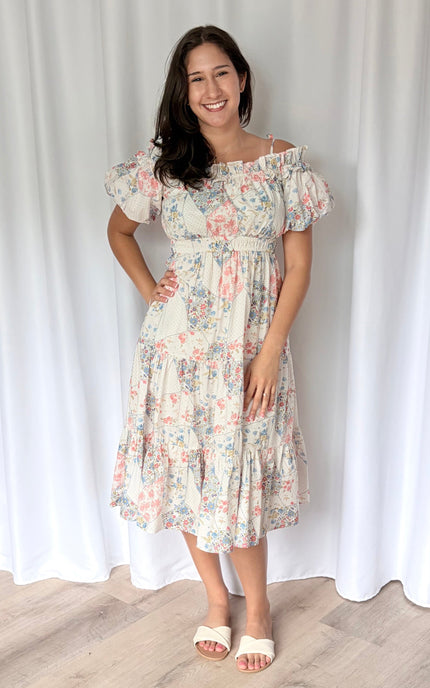 Vibrant mixed floral print off-shoulder midi dress with short puff sleeves, shirred waist, and tiered skirt in lightweight woven fabric