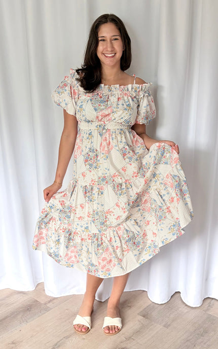 Mixed floral print tiered midi dress with off-shoulder ruffle neckline, adjustable straps, and shirred elastic waist