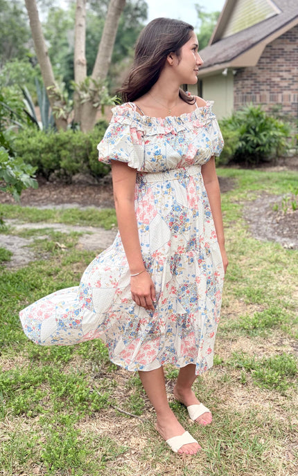 Side view of floral off-shoulder midi dress showing tiered midi length, puff sleeves, and flowy woven fabric movement