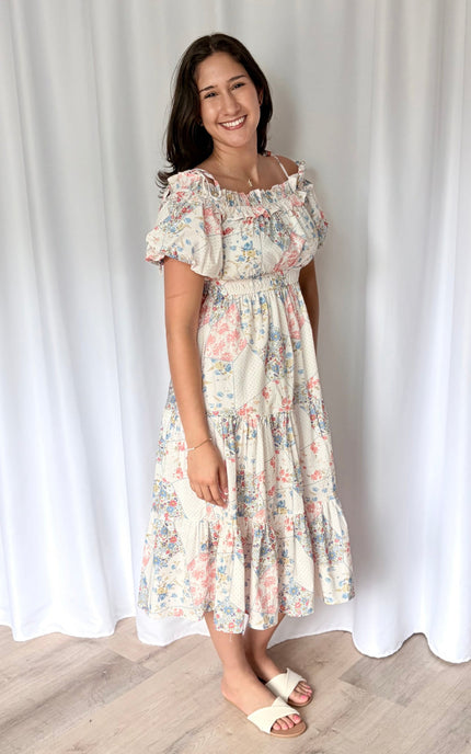 Romantic floral midi dress featuring elastic ruffled off-shoulder neckline, puff sleeves, and flowy tiered silhouette