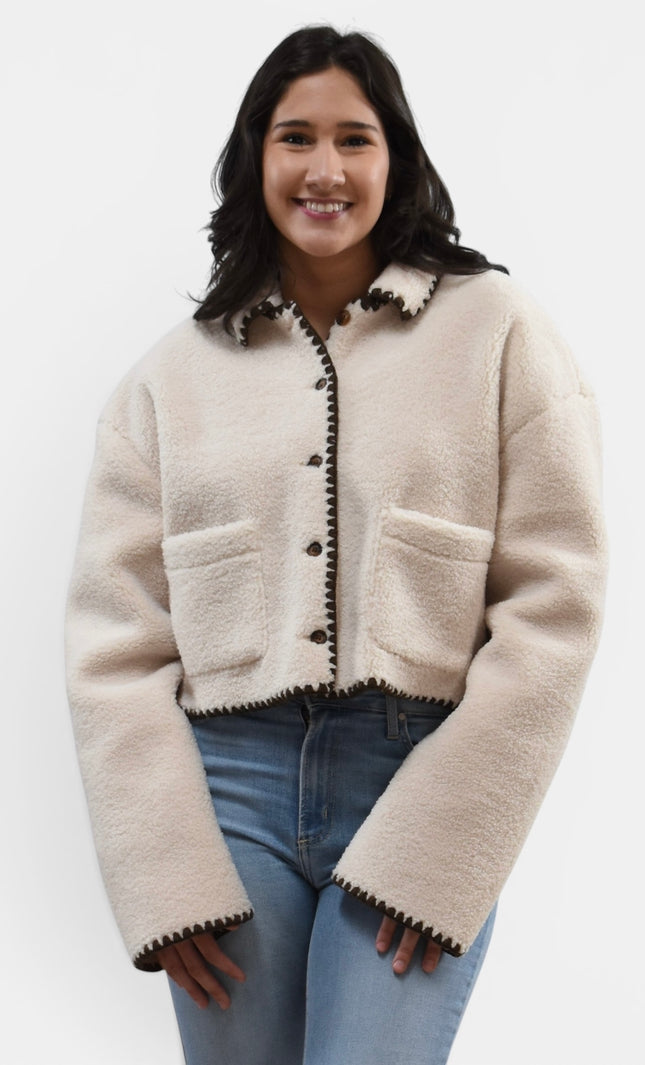 Front angle of cozy sherpa jacket with contrast stitch detail.