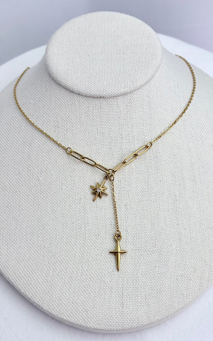 Star, cross, and tassel pendant necklace displayed on a neutral jewelry form, showing full front view and delicate drape.