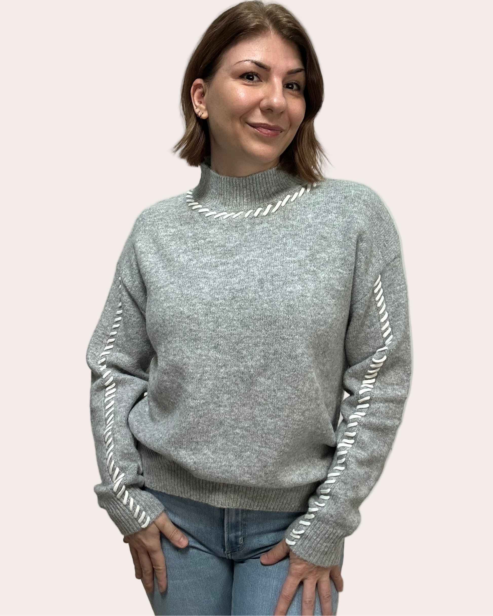 Heather grey crew-neck sweater with soft contrast stitching along the neckline and sleeves, midweight knit with stretch, photographed on a Soft Linen background for Justyna Grace Boutique.