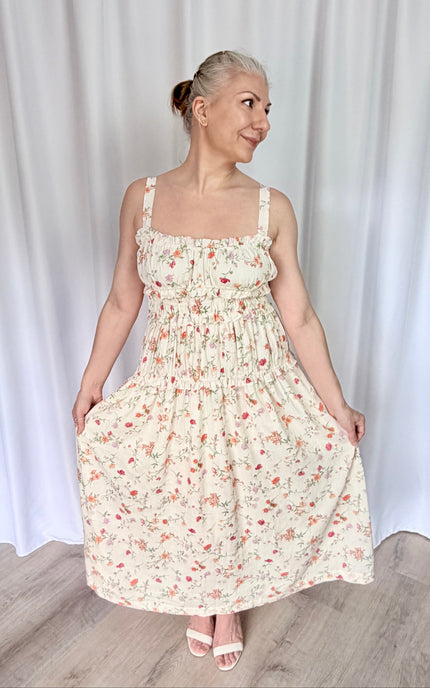 Women's floral print midi dress with sweetheart neckline, ruffled trim, and tiered shirred bodice.