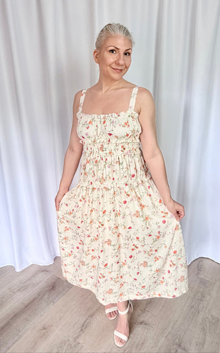 Front view floral print midi dress with romantic sweetheart neckline and flowy tiered skirt silhouette.