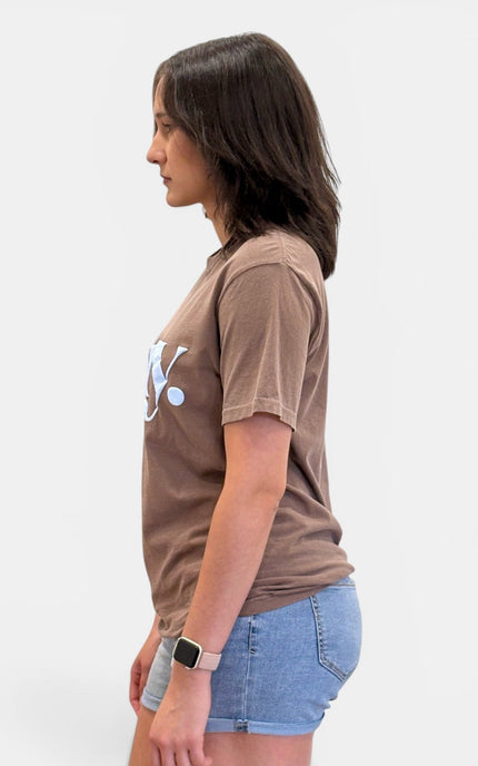 Side view of women's relaxed fit Pray graphic T-shirt.