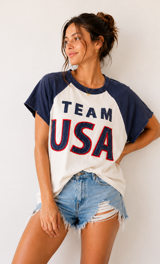 Woman wearing a 'Team USA' t-shirt against a white background