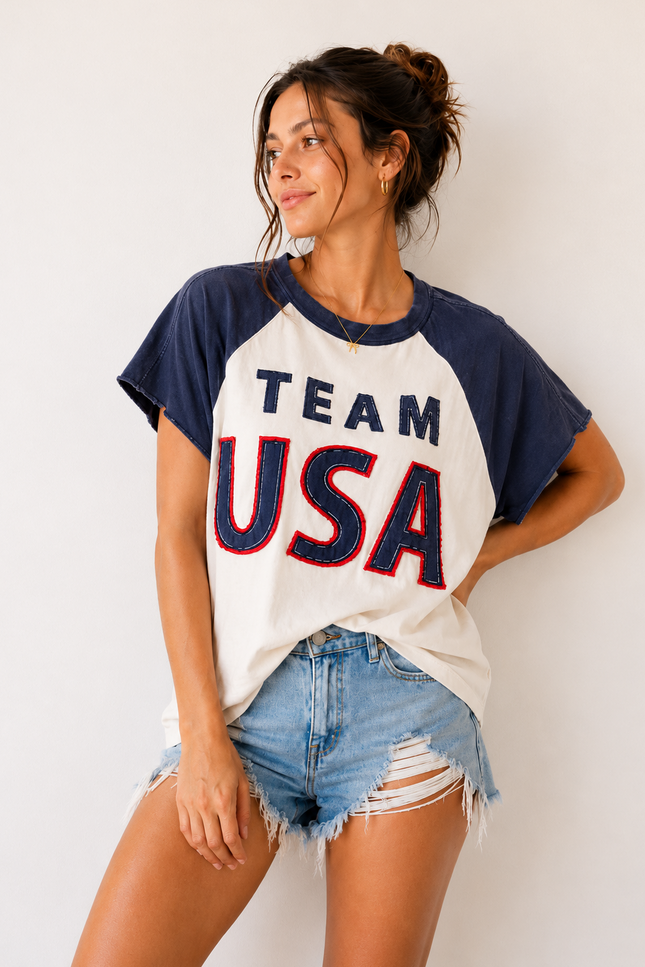 Woman wearing a 'Team USA' t-shirt against a white background