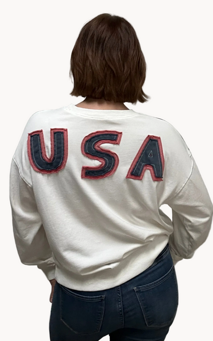 Close-up of a mineral-washed USA vintage pullover featuring an American flag patch on the front, relaxed oversized fit, and soft French terry knit — photographed for Justyna Grace Boutique.