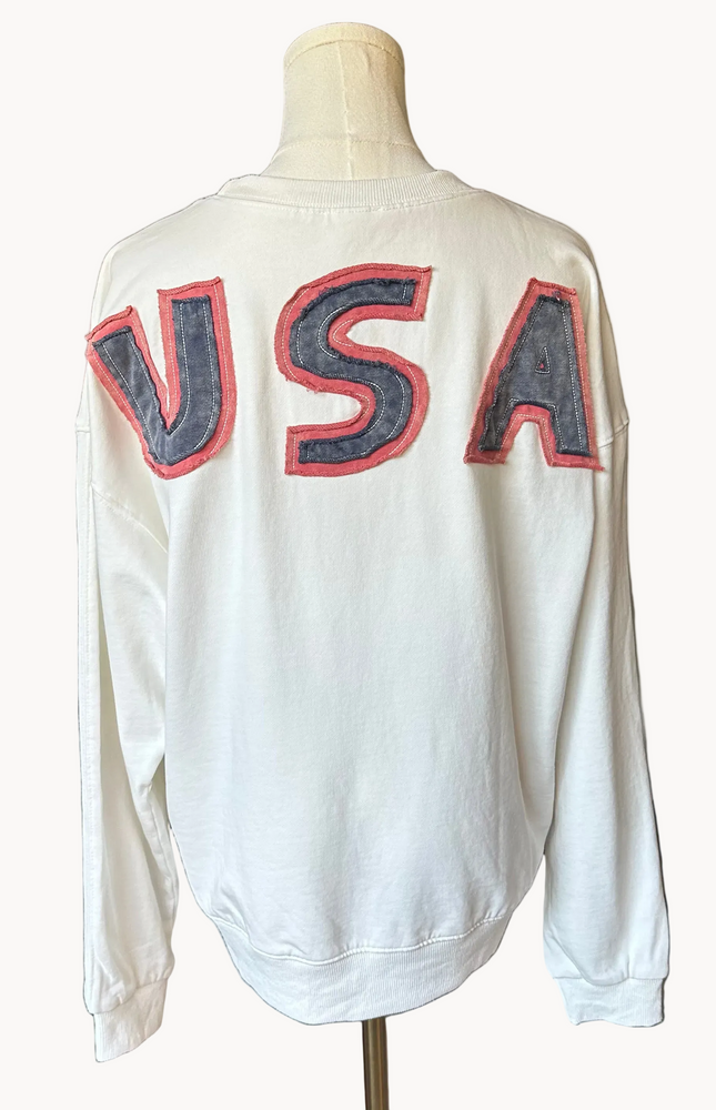 Close-up of a mineral-washed USA vintage pullover featuring an American flag patch on the front, relaxed oversized fit, and soft French terry knit — photographed for Justyna Grace Boutique.